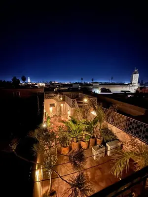 a view of a house with plants at night at Riad Home Zemrane in Marrakech