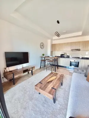 a living room with a couch and a table at Magnifique appartement Résidence DOMAINE DE NORIA in Marrakech