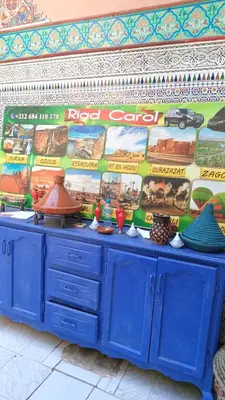 a blue cabinet in front of a wall with posters at Riad Carole - Perfect for Families & Groups in Marrakech