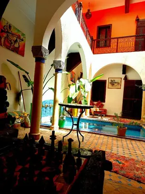 a living room with a pool in a house at Riad Rêve d Antan , Real Dream in Marrakech