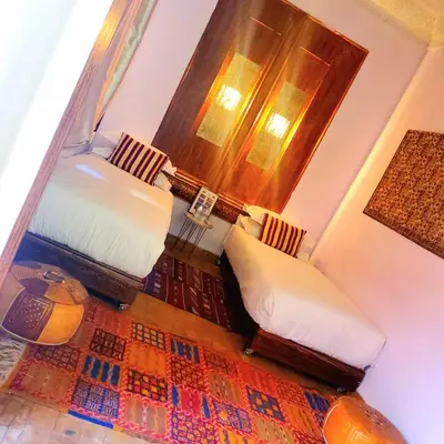 a small room with two beds and a window at Riad Rêve d Antan , Real Dream in Marrakech