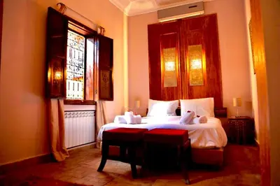 a bedroom with a bed and a window at Riad Rêve d Antan , Real Dream in Marrakech
