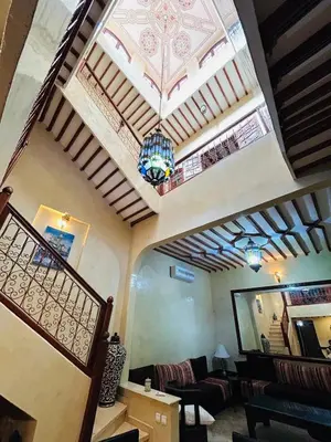 a living room with a ceiling with a chandelier at RIAD ZAKARYA in Marrakech