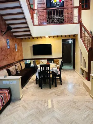 a living room with a couch and a table at RIAD ZAKARYA in Marrakech