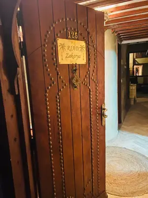 a door in a room with a sign on it at RIAD ZAKARYA in Marrakech