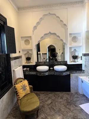 a bathroom with two sinks and a large mirror at Riad Palais Didier Six in Marrakech