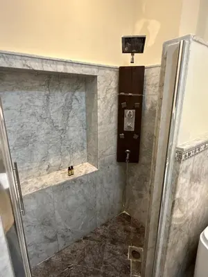 a shower with a glass door in a bathroom at Riad Palais Didier Six in Marrakech
