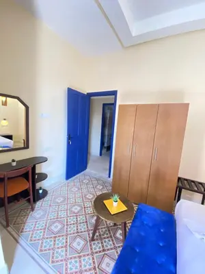 a living room with a blue couch and a table at Comfy Colonial Apartments in Marrakech
