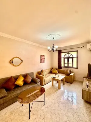 a living room with a couch and a table at Lovely 2-bedroom appartement in Marrakech