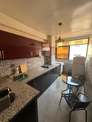 a kitchen with a counter and some chairs in it at Lovely 2-bedroom appartement in Marrakech