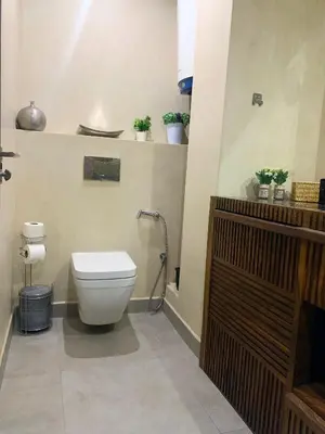 a bathroom with a toilet with plants on a shelf at Moderne, lumineux & spacieux avec balcon -Central -Wifi-Smart TV-Clim in Marrakech