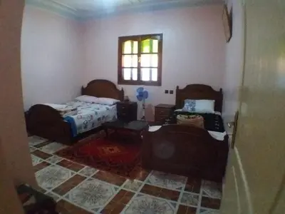 a bedroom with a bed and a table and a window at House of Travelers in Marrakech in Marrakech