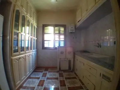 a kitchen with white cabinets and a tile floor at House of Travelers in Marrakech in Marrakech