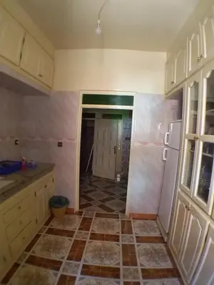 a kitchen with a tiled floor and a refrigerator at House of Travelers in Marrakech in Marrakech