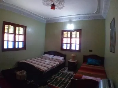 a bedroom with a bed and two windows at House of Travelers in Marrakech in Marrakech