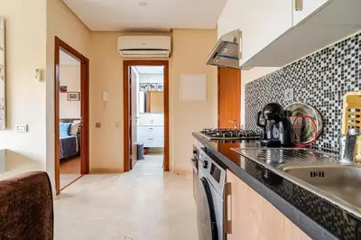 a kitchen with a sink and a counter top at Cozy Atlas Golf Studio Prestigia Marrakech in Marrakech
