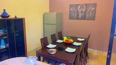 a dining room with a table and a refrigerator at Villa Marrakech in Marrakech