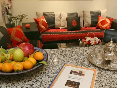 a table with a bowl of fruit on a counter at Ghita Appartement in Marrakech