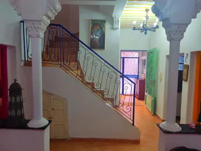 a spiral staircase in a building with a door at Dar Baddi in Marrakech
