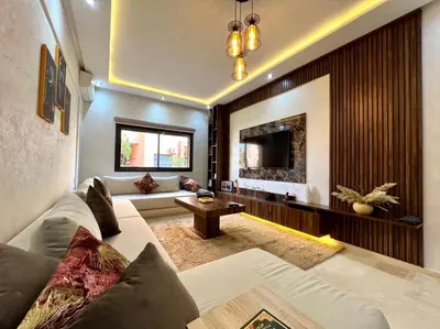 a living room with a couch and a tv at Appartement marrakech de lux in Marrakech