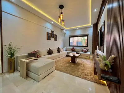 a living room with a white couch and a table at Appartement marrakech de lux in Marrakech