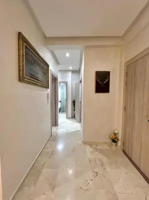 a hallway of a house with a painting on the wall at Appartement marrakech de lux in Marrakech