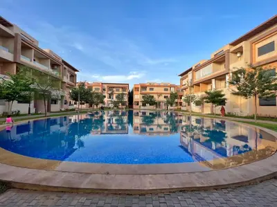 a large swimming pool in the middle of a courtyard at Appartement marrakech de lux in Marrakech