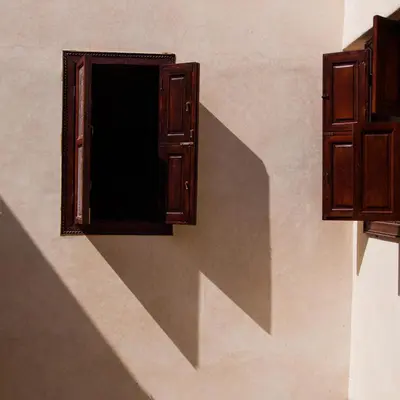 a shadow of a window on the side of a wall at Riad Of The Storks in Marrakech