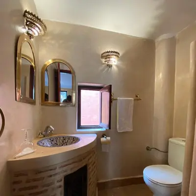 a bathroom with a sink and a toilet at Riad Of The Storks in Marrakech