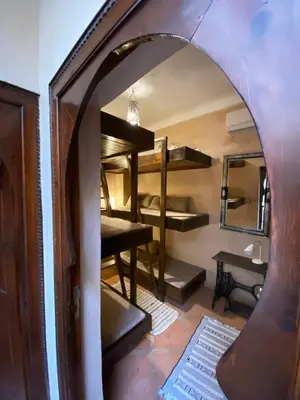 a room with bunk beds and a mirror at Riad Of The Storks in Marrakech