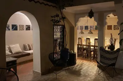 a living room with a couch and a table and chairs at Riad Of The Storks in Marrakech