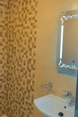 a bathroom with a sink and a mirror at Appartement Nour 5 Marrakech Centre Gueliz avec piscine in Marrakech