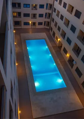 a swimming pool in the middle of a building at Appartement Nour 5 Marrakech Centre Gueliz avec piscine in Marrakech