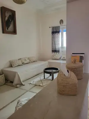 a living room with a couch and a table at Riad MsHolidays bassin privatisé Marrakech in Marrakech