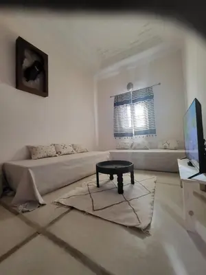a living room with a couch and a coffee table at Riad MsHolidays bassin privatisé Marrakech in Marrakech