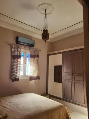 a bedroom with a bed and a window at Riad MsHolidays bassin privatisé Marrakech in Marrakech