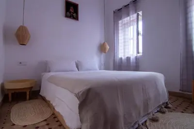 a bedroom with a white bed and a window at The Loft in Marrakech