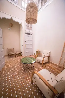 a room with chairs and a table in a room at The Loft in Marrakech