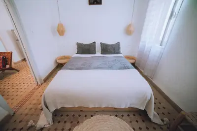 a bedroom with a large white bed with two pillows at The Loft in Marrakech