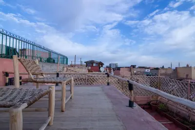 a balcony with a bench and a view of the city at The Loft in Marrakech