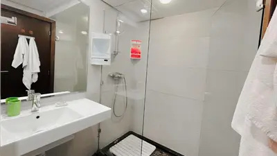 a white bathroom with a sink and a shower at BAGATELLE STUDIO GUELIZ in Marrakech