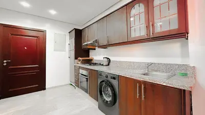 a kitchen with a sink and a washing machine at BAGATELLE STUDIO GUELIZ in Marrakech