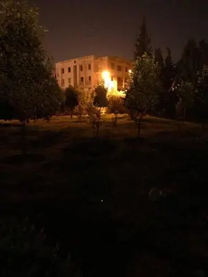 a building with a light in the middle of a park at night at Beautiful Luxury 2 bedrooms Apartment in Marrakech in Marrakech