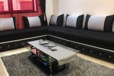 a black couch with a table in a living room at Beautiful Luxury 2 bedrooms Apartment in Marrakech in Marrakech