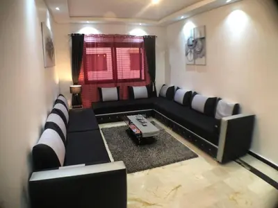 a living room with a black and white couch at Beautiful Luxury 2 bedrooms Apartment in Marrakech in Marrakech