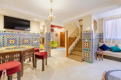 a living room with a staircase and a couch at Appartement moderne en City Center Marrakech-Gueliz in Marrakech