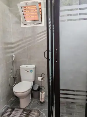 a small bathroom with a toilet and a window at Résidence NAJD C - Appartement T2 in Marrakech