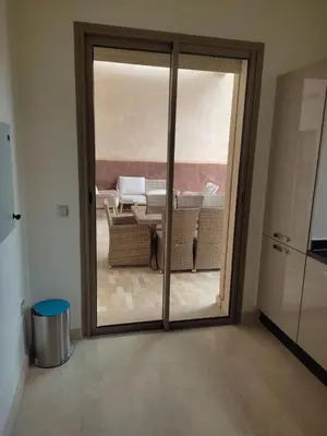 a sliding glass door with a view of a patio at Villa isolée 4 façades avec piscine in Marrakech
