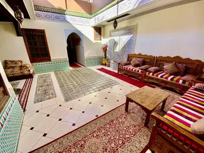 a living room with a couch and a table at Riad Jibraile in Marrakech