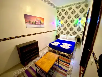 a small room with a bed and a fireplace at Riad Jibraile in Marrakech